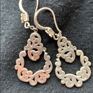 One pair dangle Louis Hill Earrings.